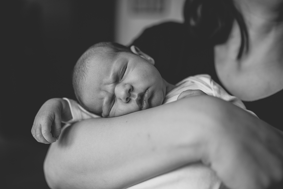 Babybild mit Fokus auf Geborgenheit. Das Foto entstand auf Mamas Arm.
